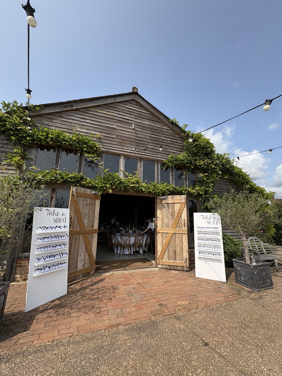 High Billinghurst Farm barn wedding venue in Surrey with festoon lighting